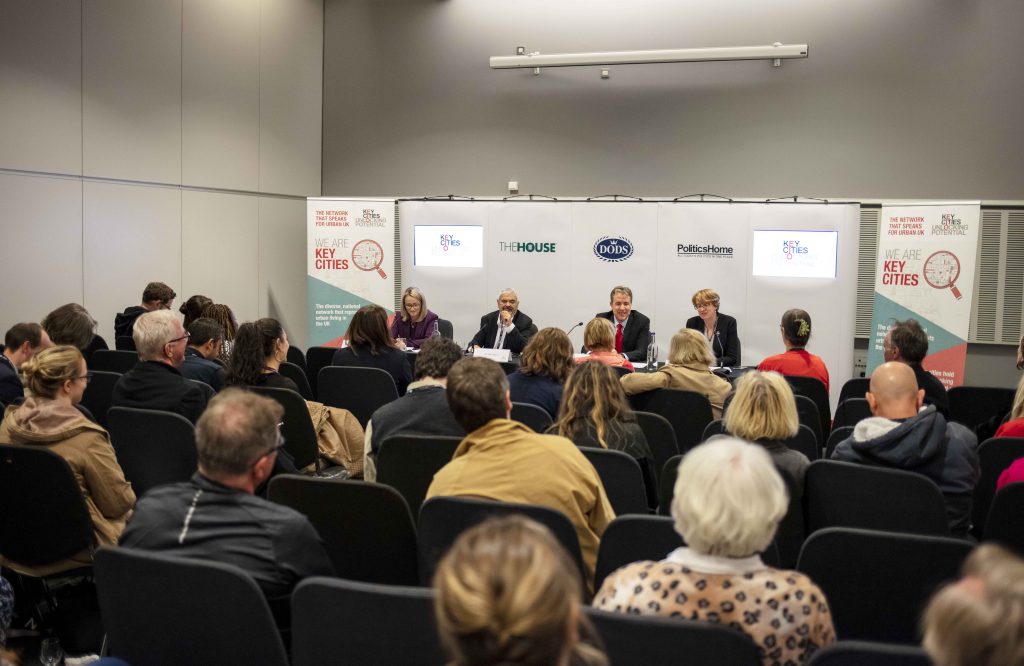 Seated people attending a panel discussion